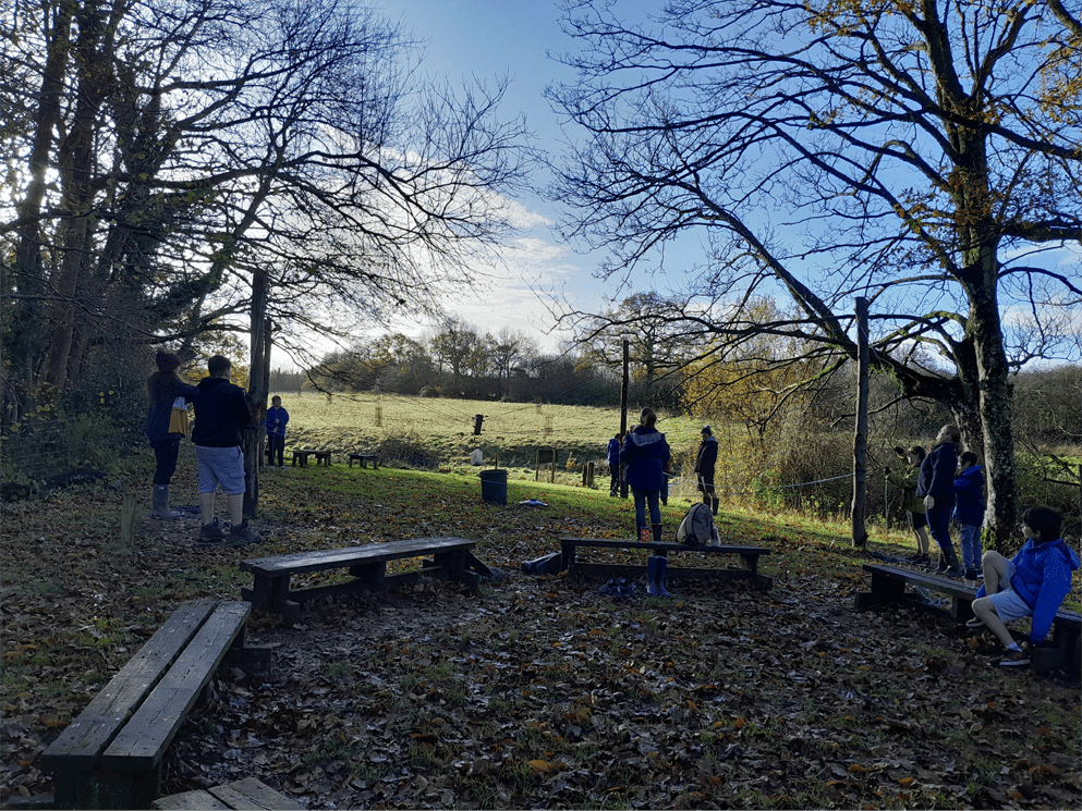 Magdalen Farm staff explaining the low-ropes course to Highgate learners and staff from Highgate Hill House.